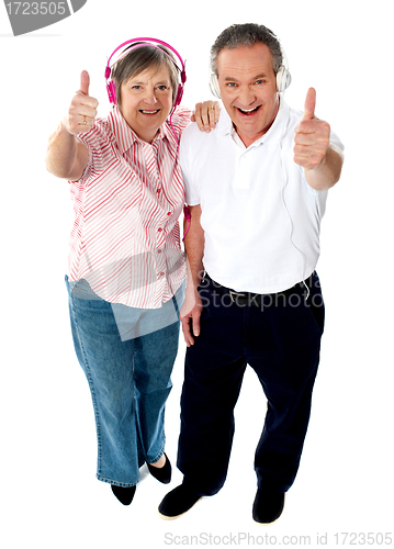 Image of Thumbs-up couple tuned into music
