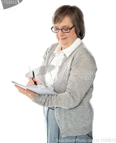 Image of Portrait of a businesswoman writing notes