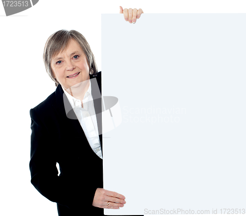 Image of Female executive holding blank whiteboard
