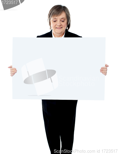 Image of Portrait of a business lady holding a blank billboard