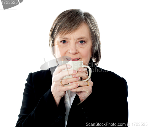 Image of Old woman holding coffee mug