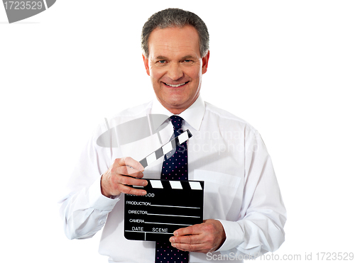 Image of Aged corporate male holding clapperboard