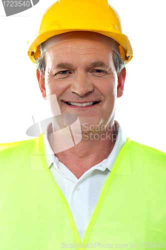 Image of Smiling senior builder wearing hardhat