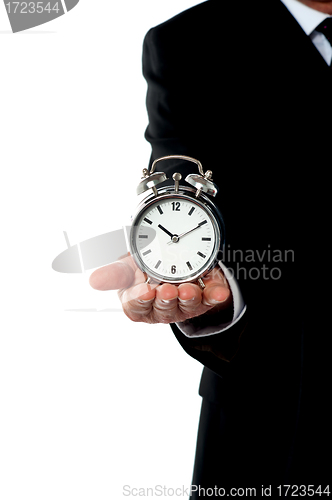 Image of Cropped image of a man with alarm clock on his palm