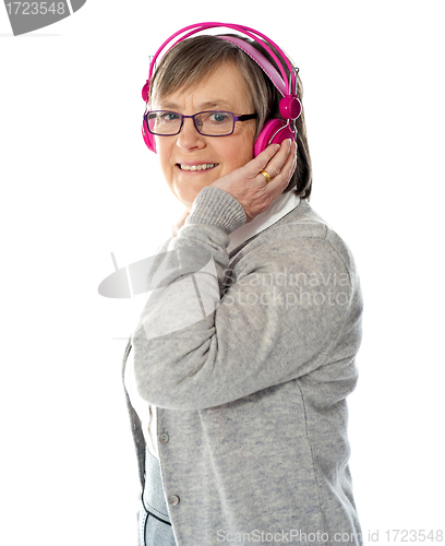 Image of Aged woman enjoying music