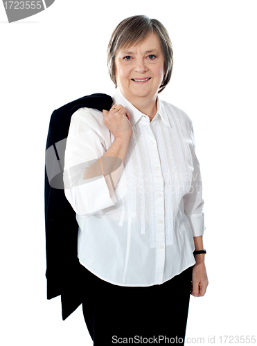 Image of Senior female executive holding coat over her shoulders