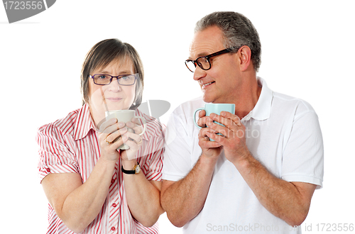 Image of Happy matured couple holding cofee mug