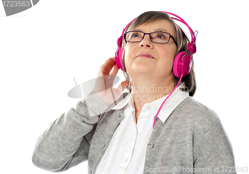 Image of Old woman looking up, lost in musical world