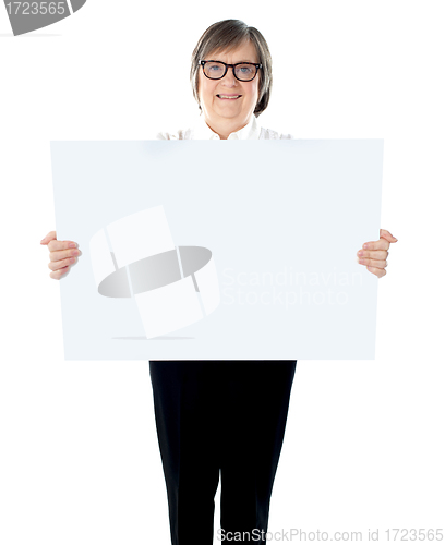 Image of Senior businesswoman posing with blank placard