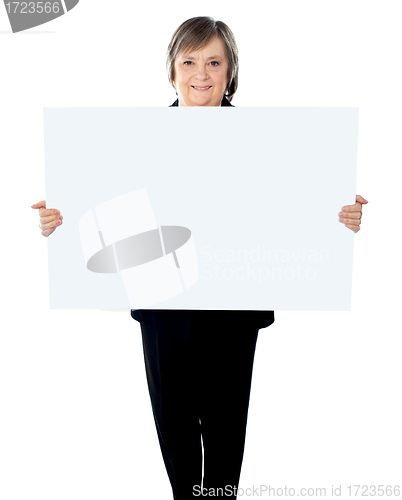 Image of Female executive standing with a blank billboard