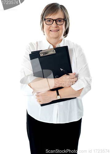 Image of Portrait of senior businesswoman holding reports