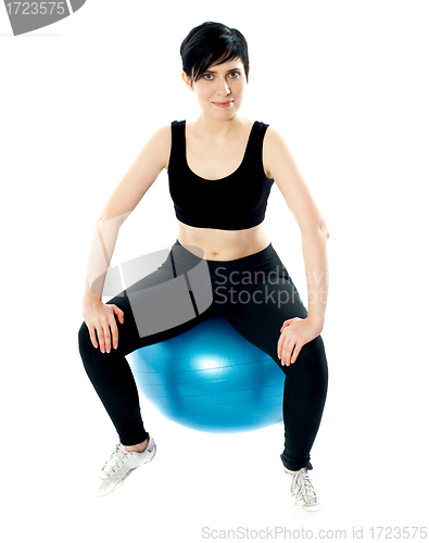 Image of Young athlete sitting on a swiss ball