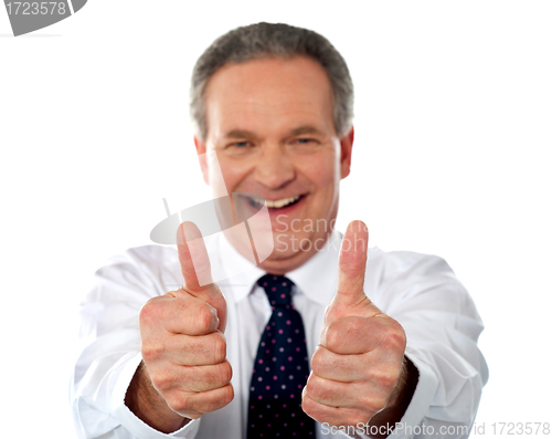 Image of Happy businessman gesturing double thumbs-up