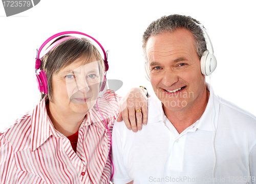 Image of Cute senior couple listening to music together