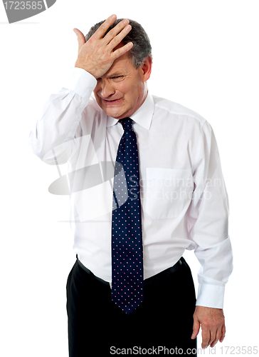 Image of Sad old corporate man with hand on head
