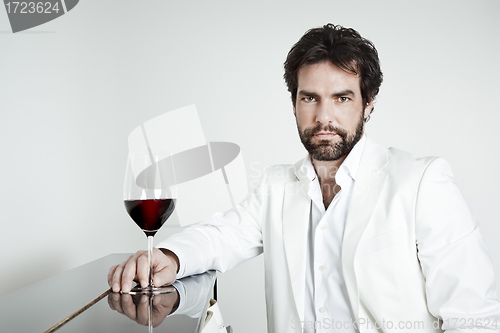 Image of handsome man and a glass of red wine