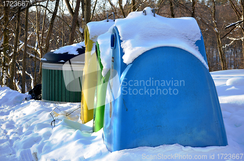 Image of Waste sort containers covered with snow in winter 