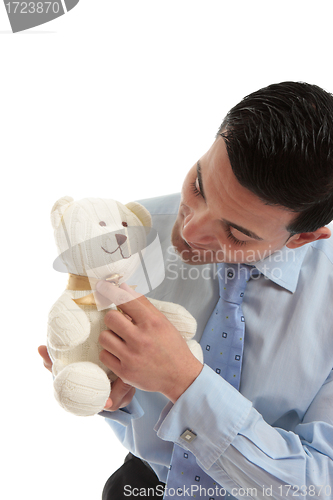 Image of Salesman holding a teddy bear