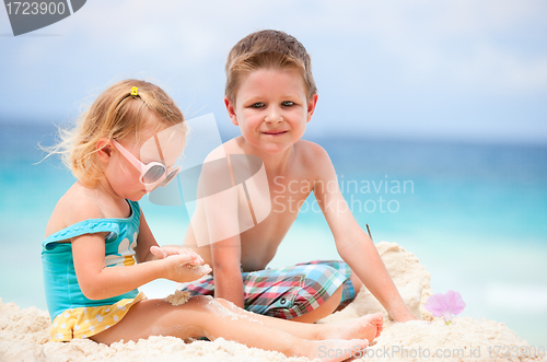 Image of Two kids playing together at beach