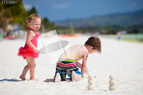 Image of Two adorable kids standing by ocean shore