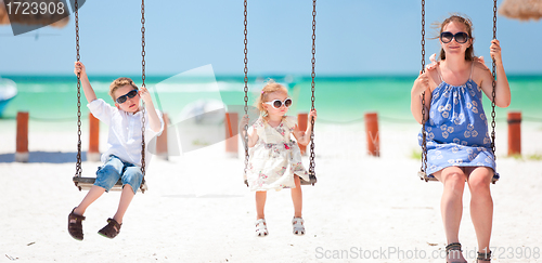 Image of Family swinging