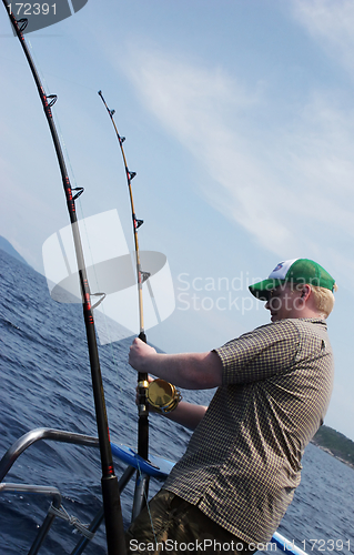 Image of Man deep sea fishing