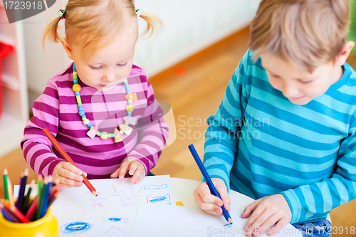 Image of Brother and sister drawing in their room