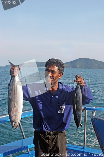 Image of Thai fishing operator holding fish after a deep sea fishing trip