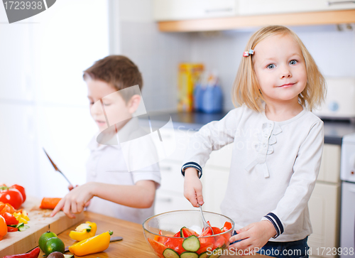 Image of Two little kids making salad