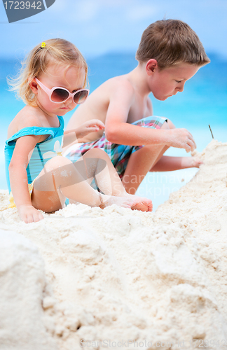 Image of Two adorable kids playing together at beach