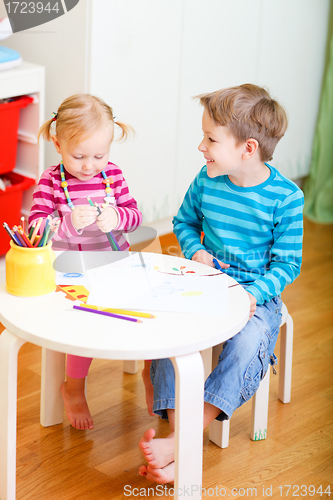 Image of Two kids drawing together