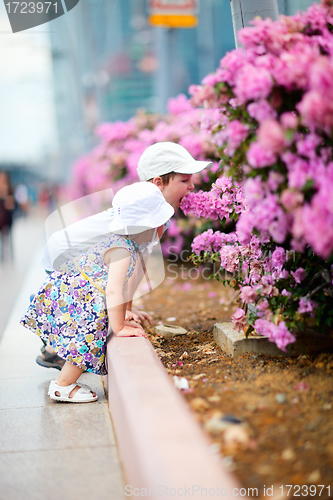 Image of Two kids outdoor in city at summer day