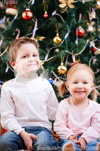 Image of Two kids near Christmas tree