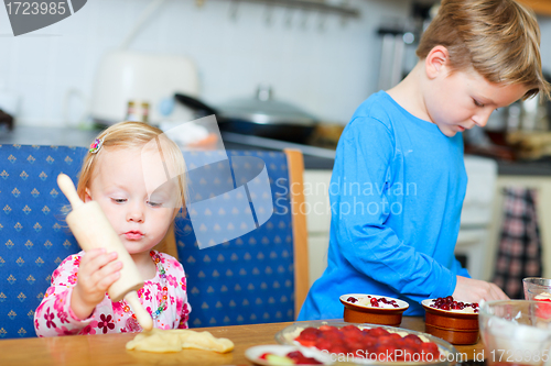Image of Two kids helping to bake pie 
