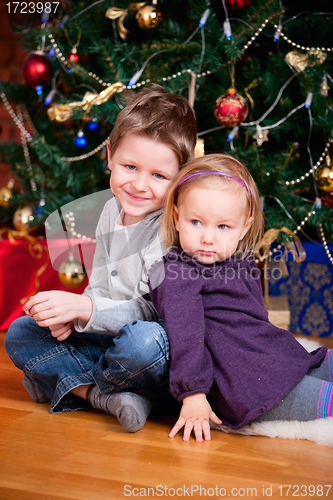 Image of Two kids near Christmas tree