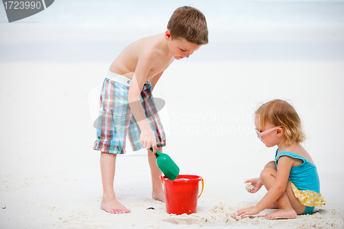 Image of Two adorable kids playing together at beach