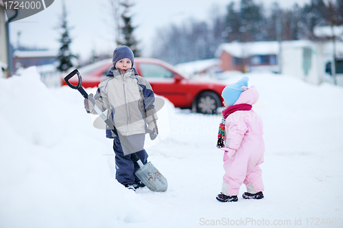 Image of Two kids outdoors at snowy winter day