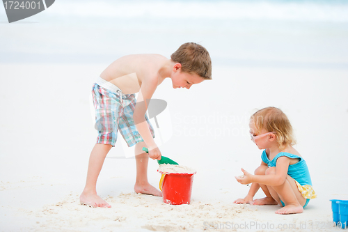 Image of Two kids playing together at beach