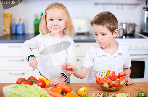 Image of Two little kids making salad