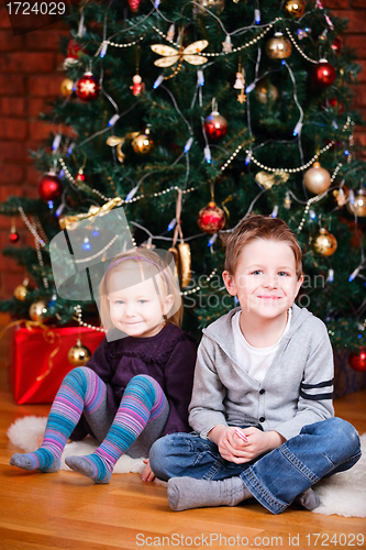 Image of Two kids near Christmas tree