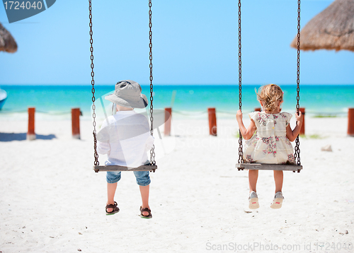 Image of Little kids swinging