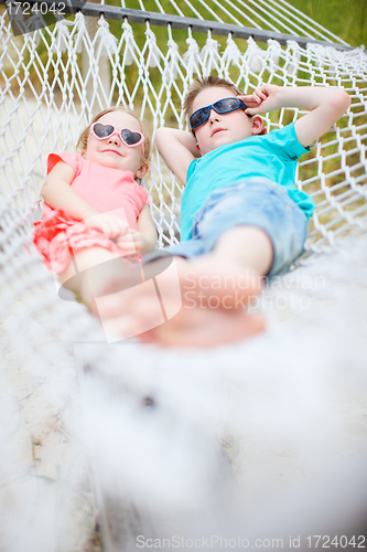 Image of Kids relaxing in hammock