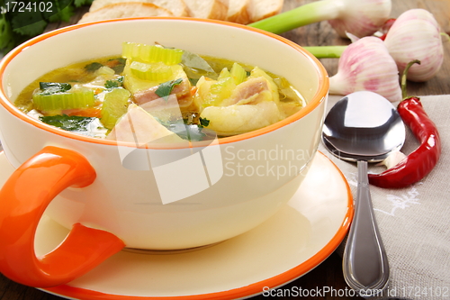 Image of Fish soup with vegetables in a bowl.