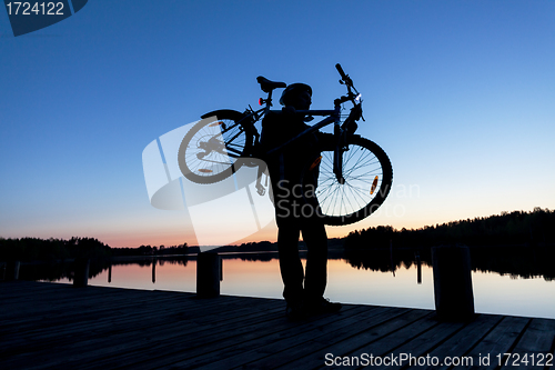 Image of Silhouette of a Cyclist on the Sunset Sky