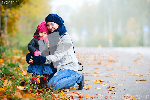 Image of Mother and daughter outdoors on foggy day