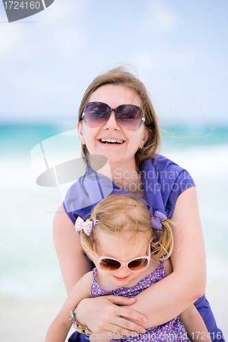 Image of Happy mother and daughter at beach