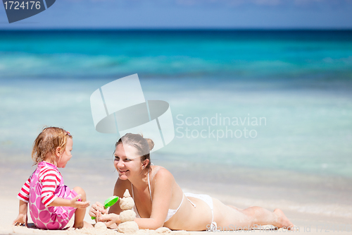 Image of Mother and daughter playing with sand