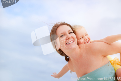 Image of Mother and daughter having fun outdoors
