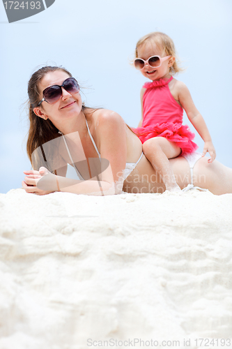 Image of Mother and daughter relaxing at beach