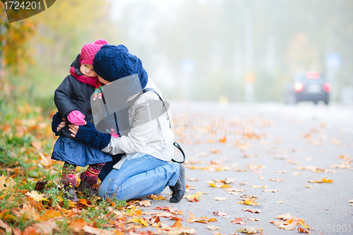 Image of Mother and daughter outdoors on foggy day